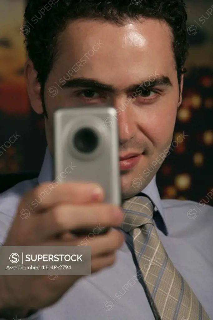Businessman with phone camera
