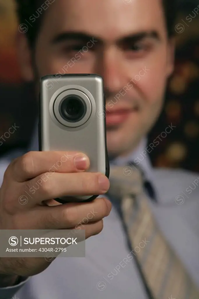 Businessman with phone camera