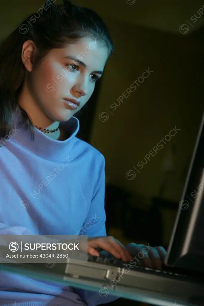 Teenager busy on the computer.