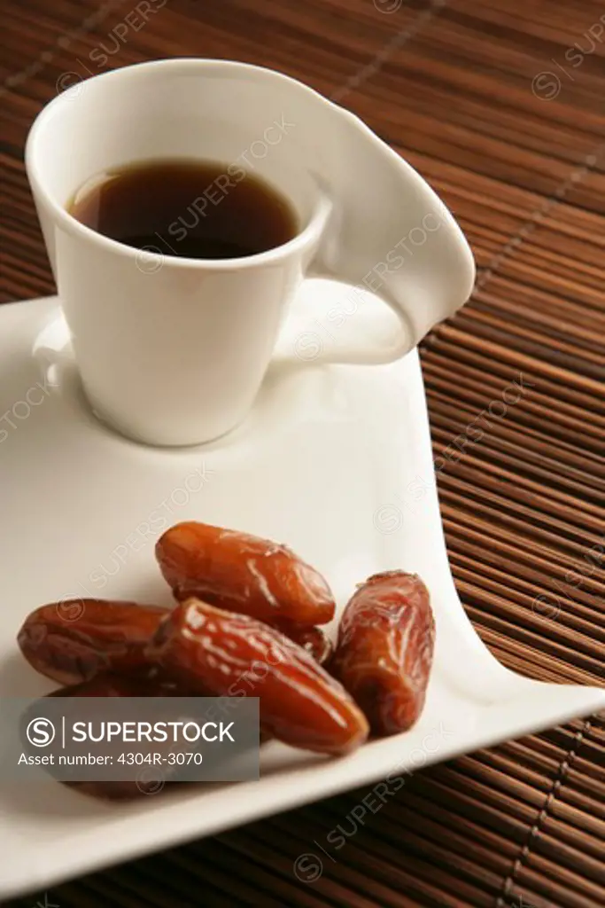 Cups of coffee and dates.