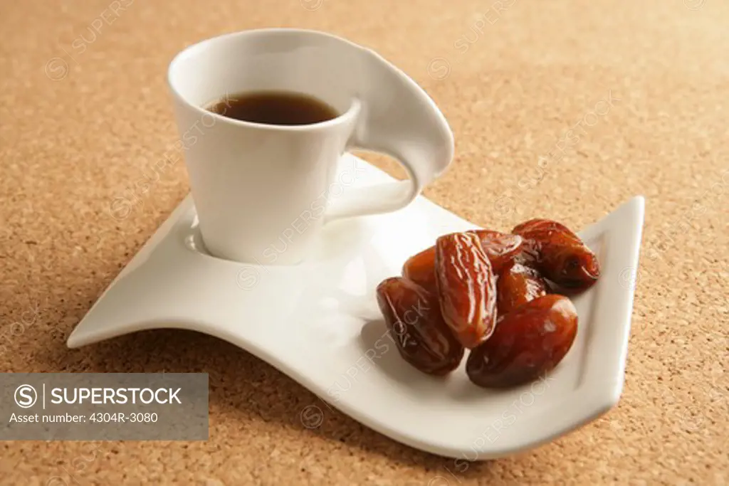 Cups of coffee and dates.