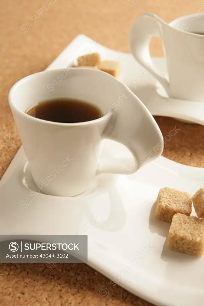 Cups of coffee and sugar.