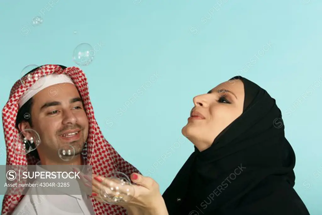 Arab couple playing the bubbles