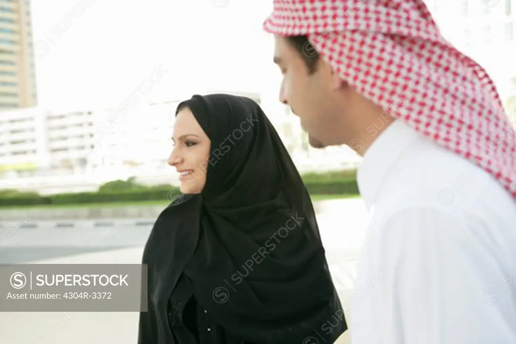 Arab couple looking away