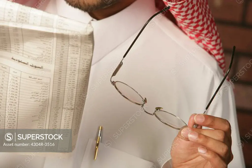 Arab Man reading the newspaper