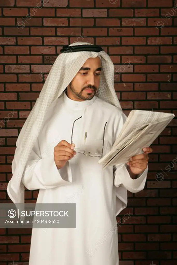 Arab Man reading the newspaper