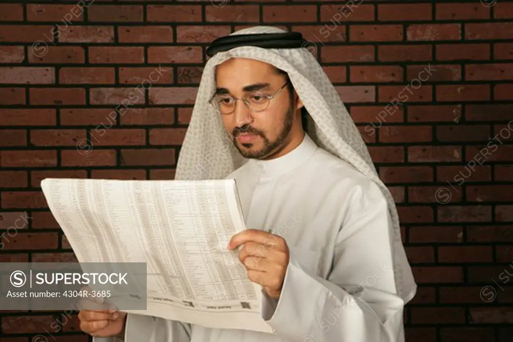 Arab Man reading newspaper