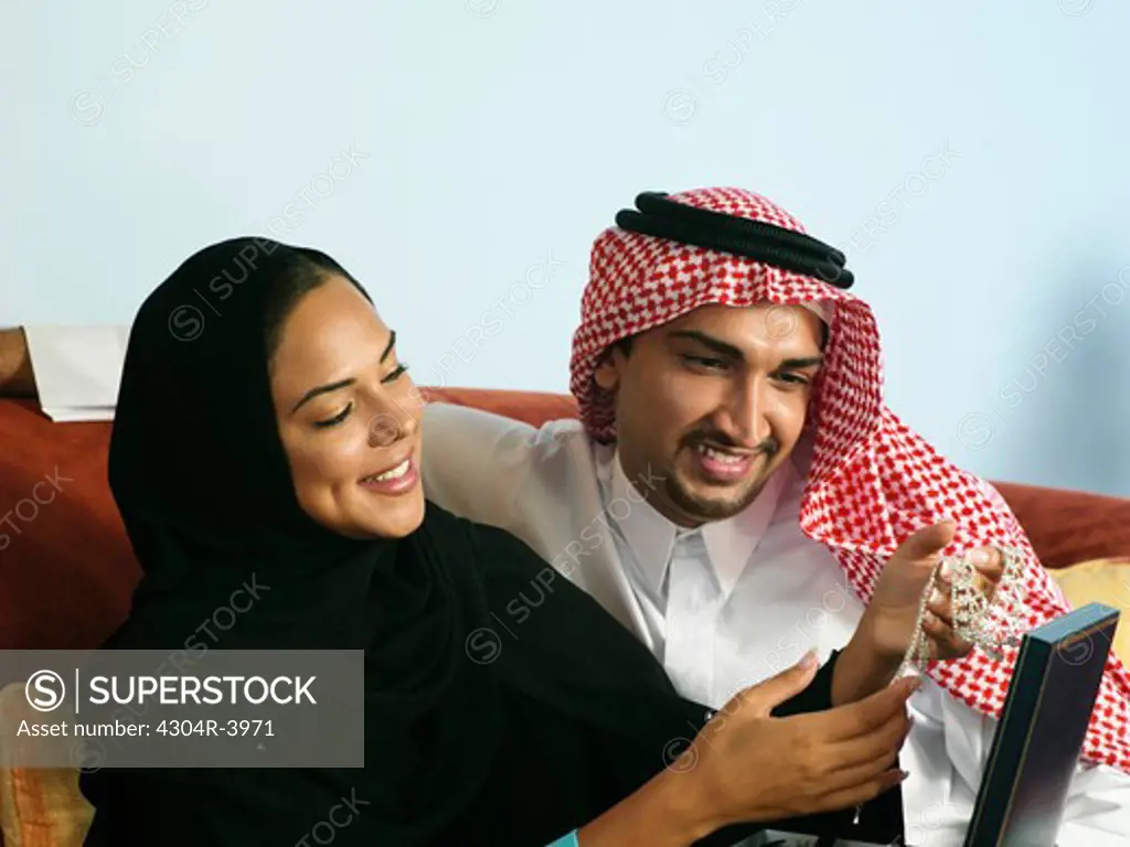Arab man give a present to his wife