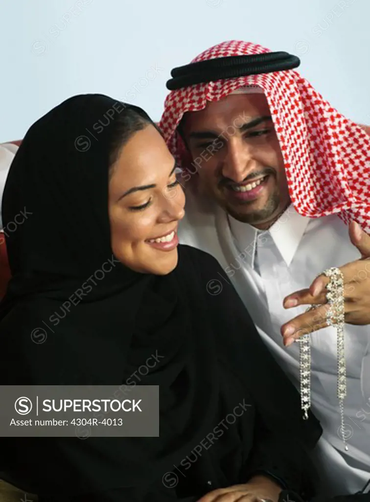 Arab man gives a present to his wife
