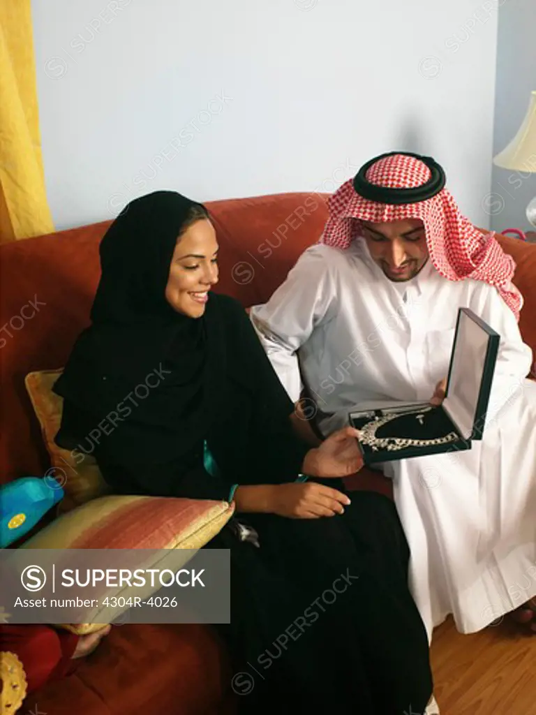 Arab man give a present to his wife