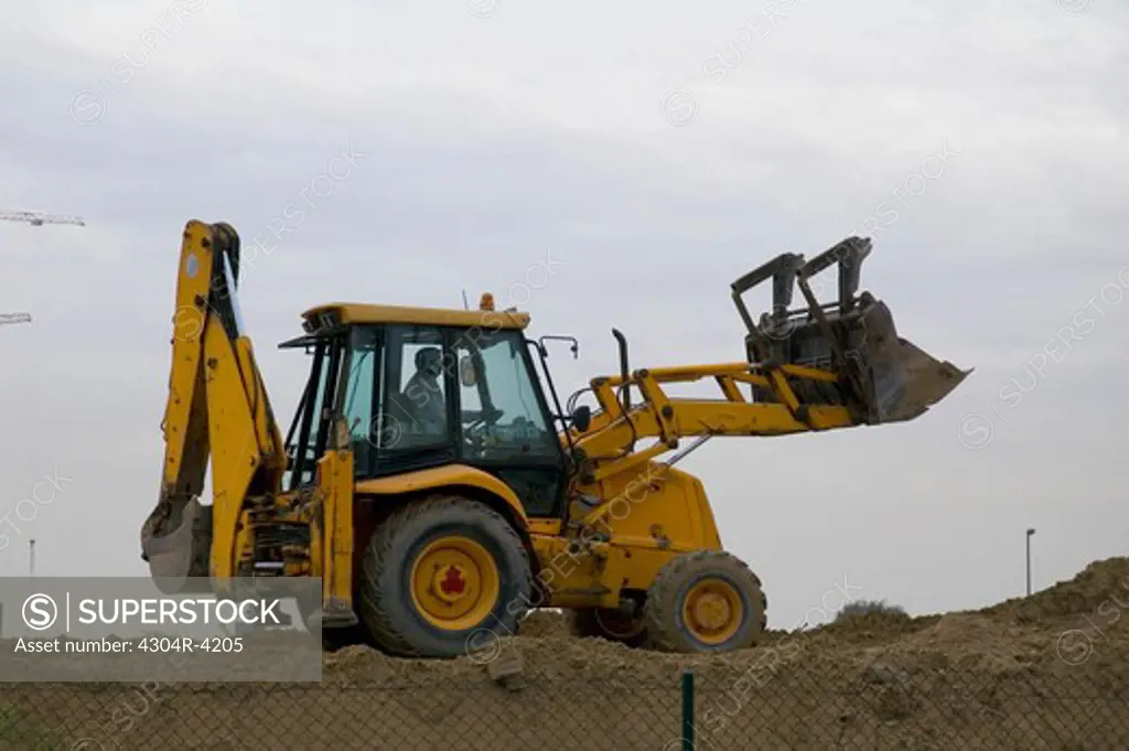 View of a machine digging the sand