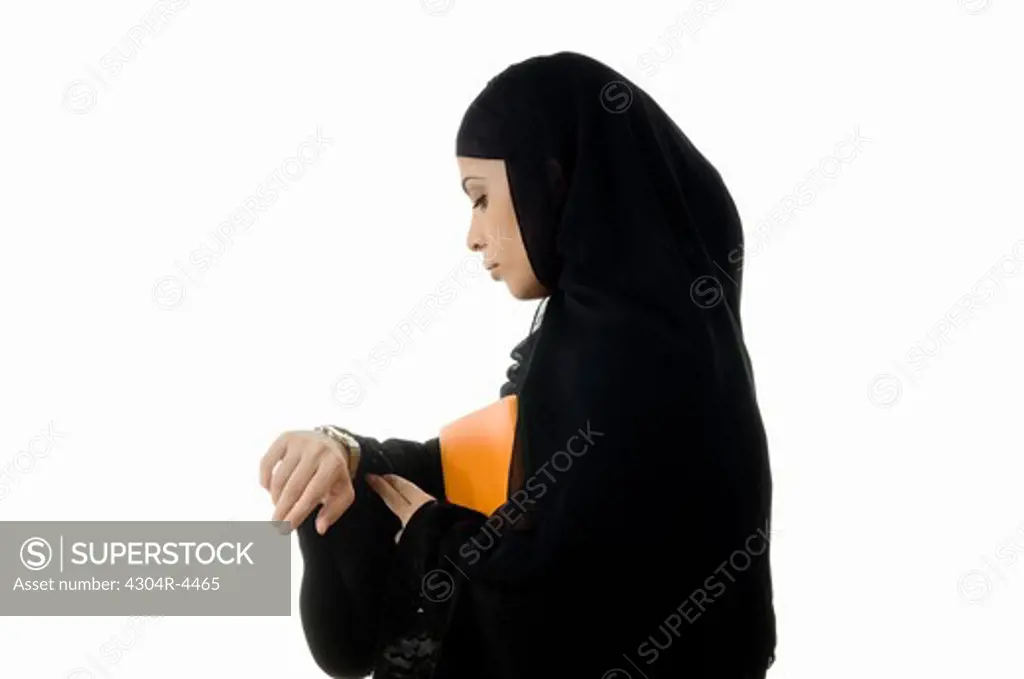 Arab Lady holding documents, looking at her watch