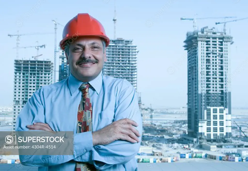 Portrait of a Engineer with the building constructions in the background in Dubai