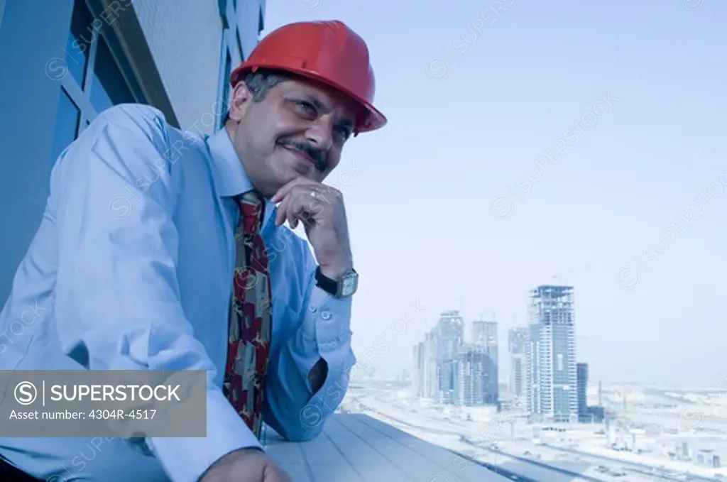 Portrait of a Engineer with the building constructions in the background in Dubai