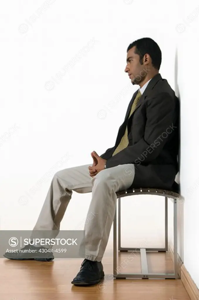 Young man sitting waiting