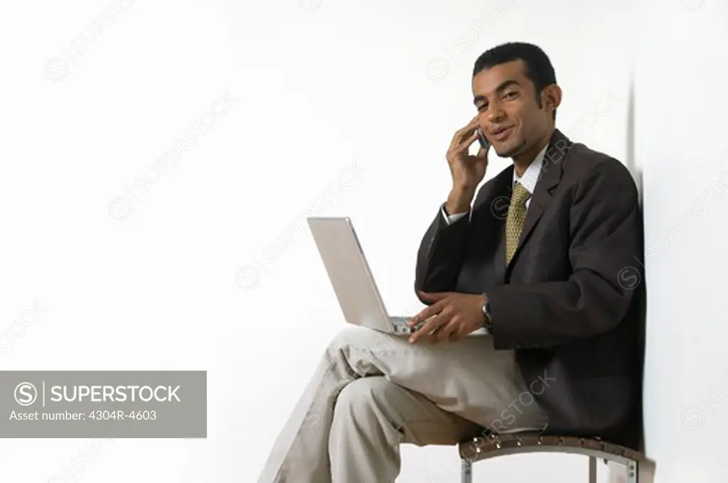 Young man sitting with a laptop computer