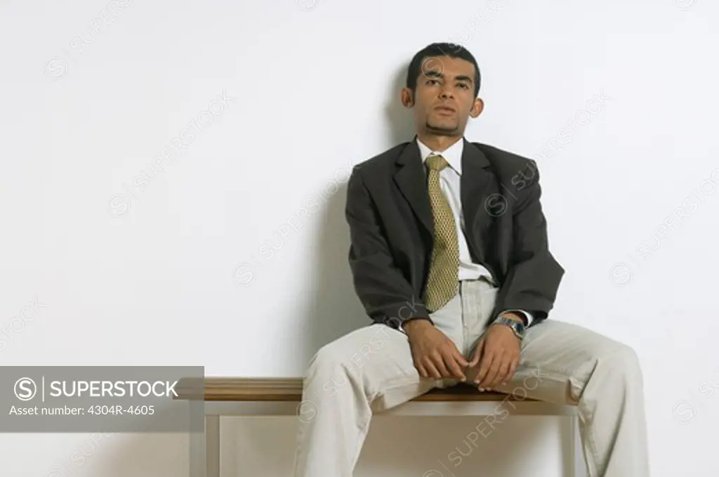 Young man sitting & waiting