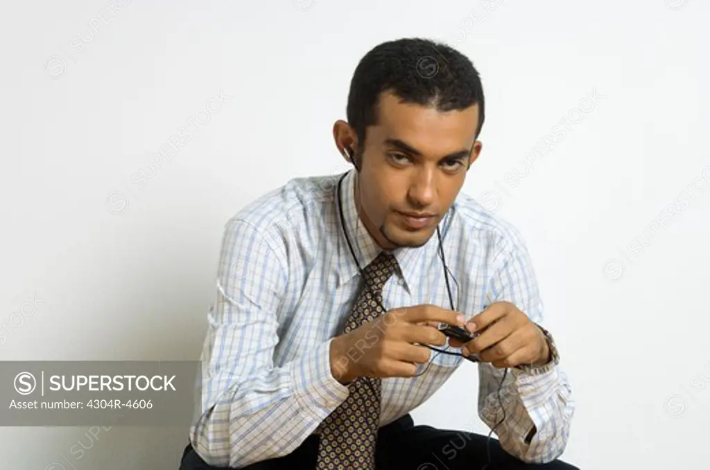 Young man sitting listening to music