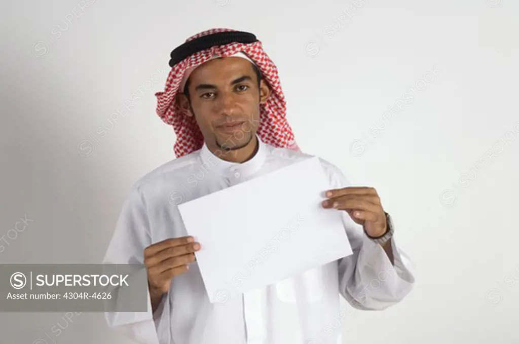 Young Arab man showing a paper