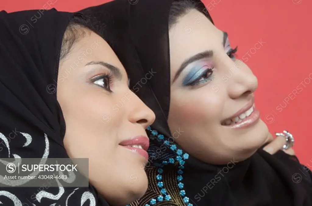 Two Arab Ladies standing cheek to cheek