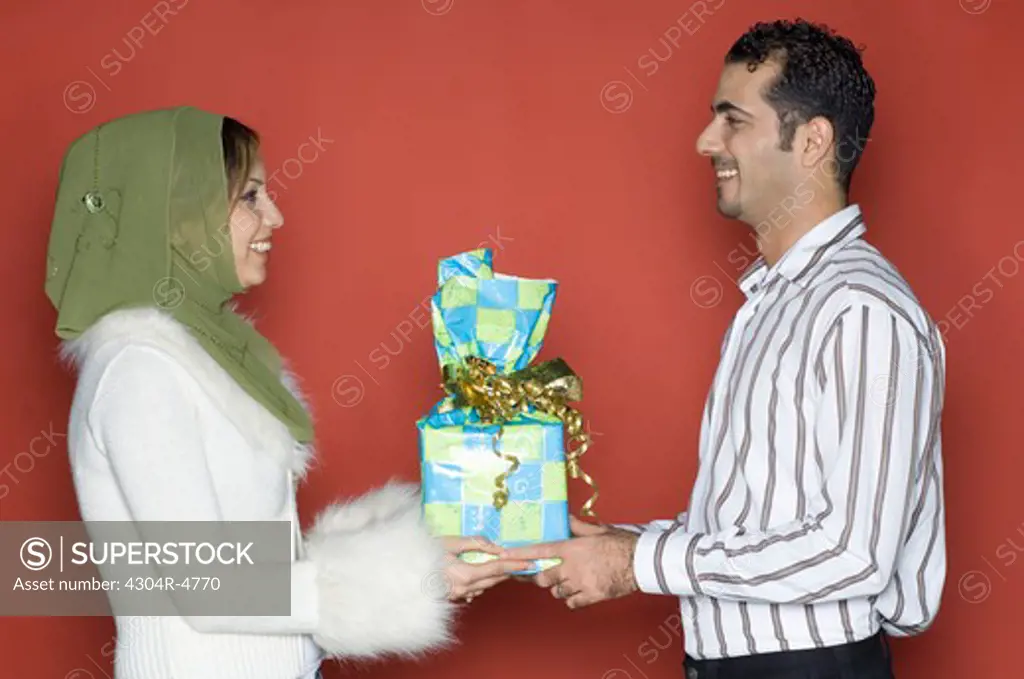 Couple holding present