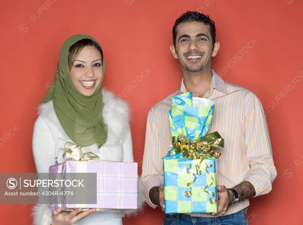Couple holding presents