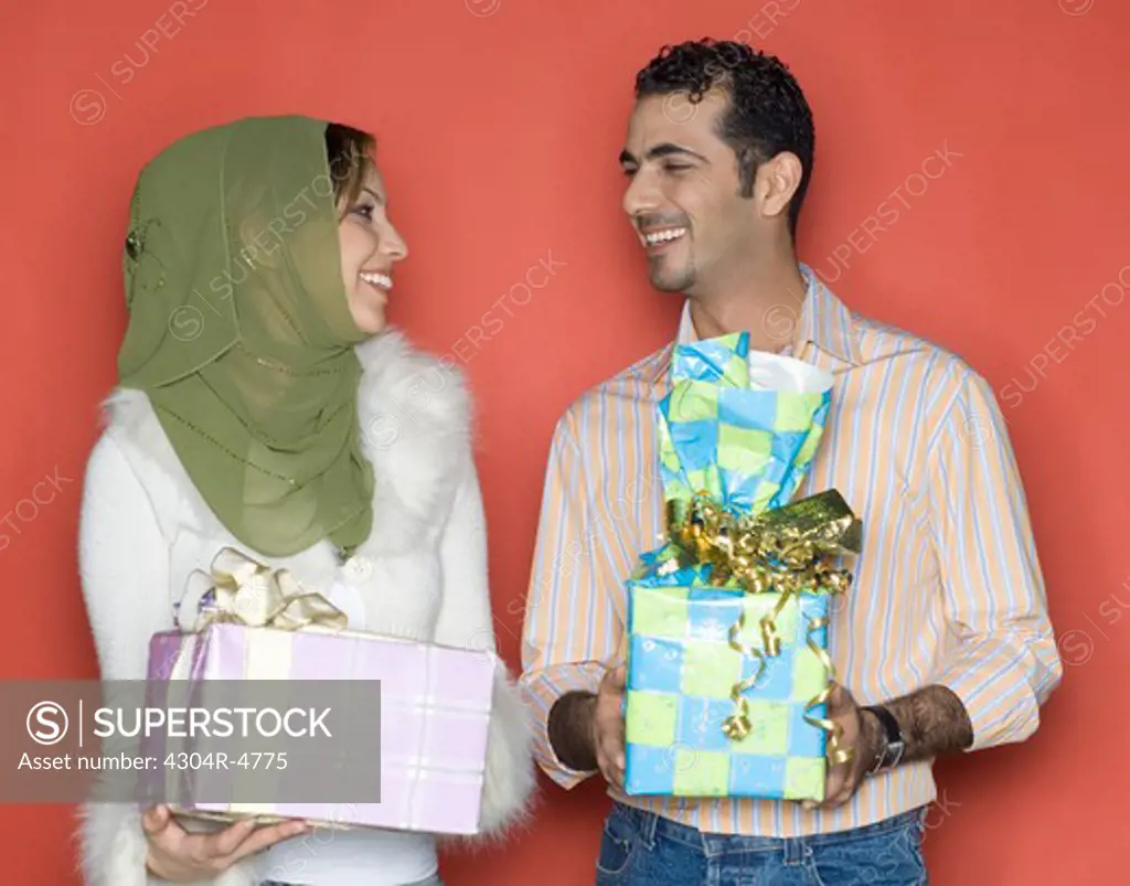 Couple holding presents
