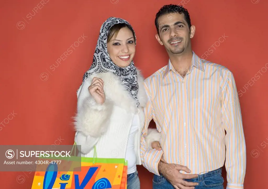 Couple smiling and holding shopping bag
