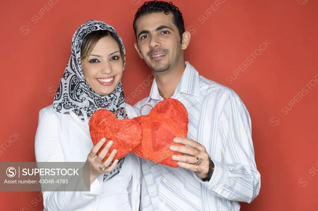 Young Couple holding heart shaped object