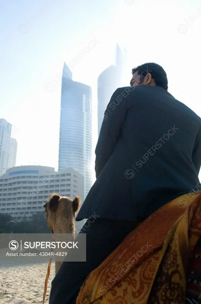 Businessman sitting on camel