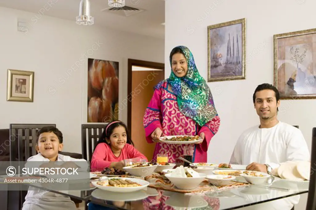 Arab Family looking at camera while dining