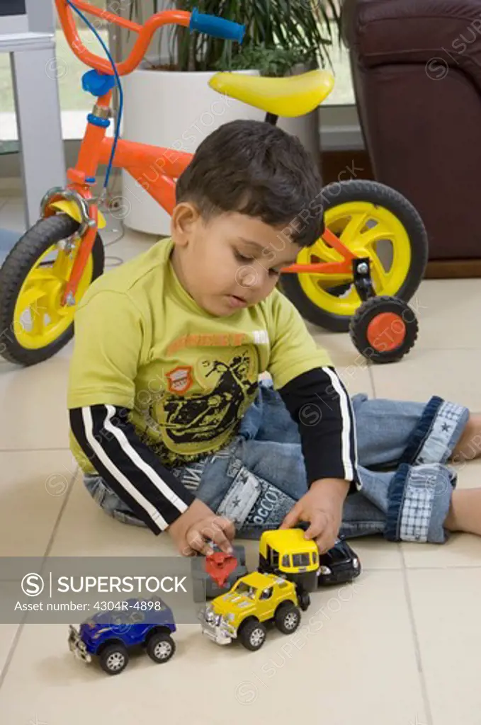 Young boy playing with toys in the living room