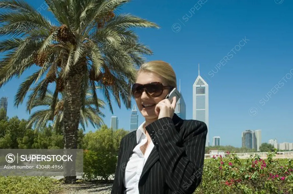 Young Businesswoman outdoors with modern office towers seen in the background