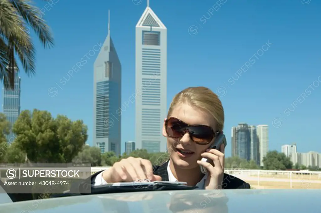 Young Businesswoman outdoors with modern office towers seen in the background
