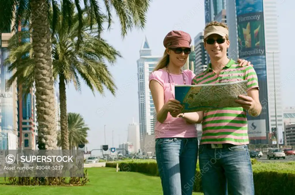 Couple looking at map, United Arab Emirates