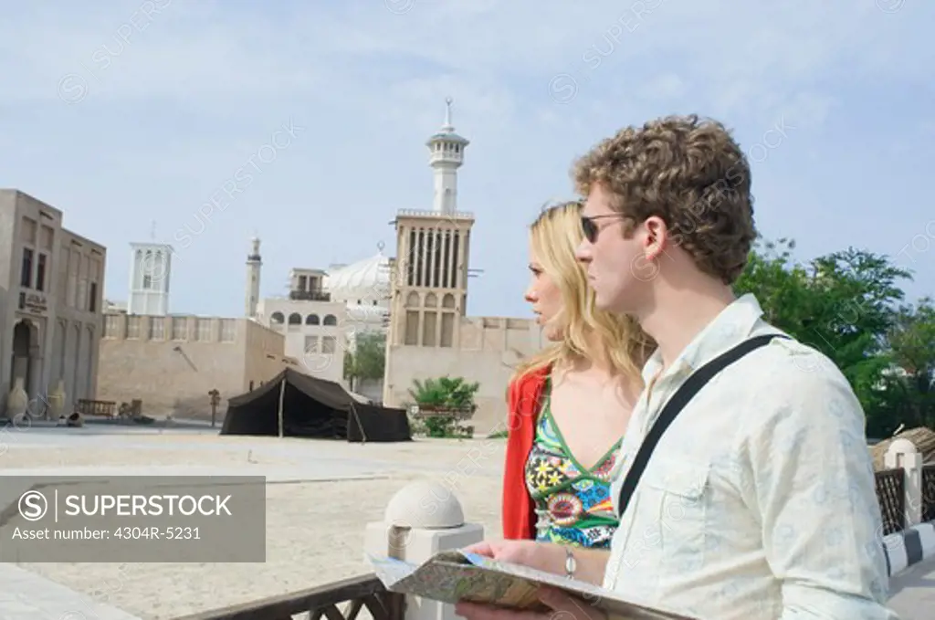 Couple looking at traditional architecture, Dubai, United Arab Emirates