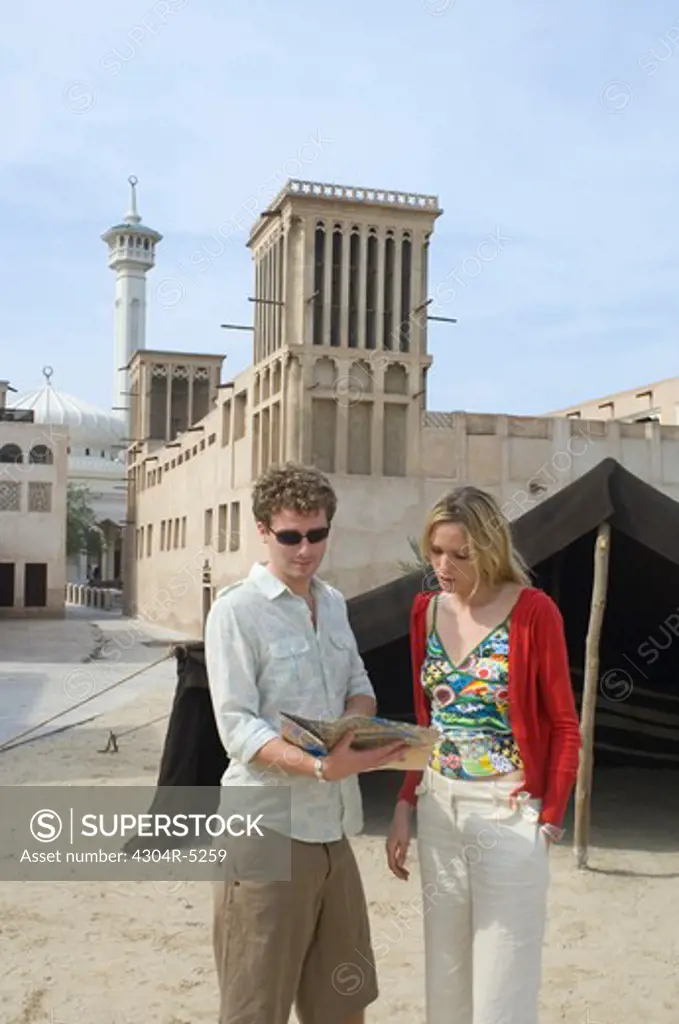 Couple looking at traditional architecture, Dubai, United Arab Emirates