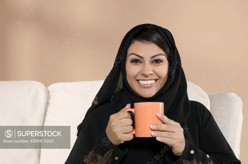 Young woman holding mug, portrait