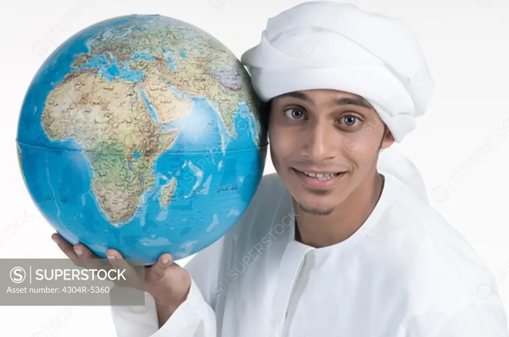 Young man holding globe, portrait, close-up