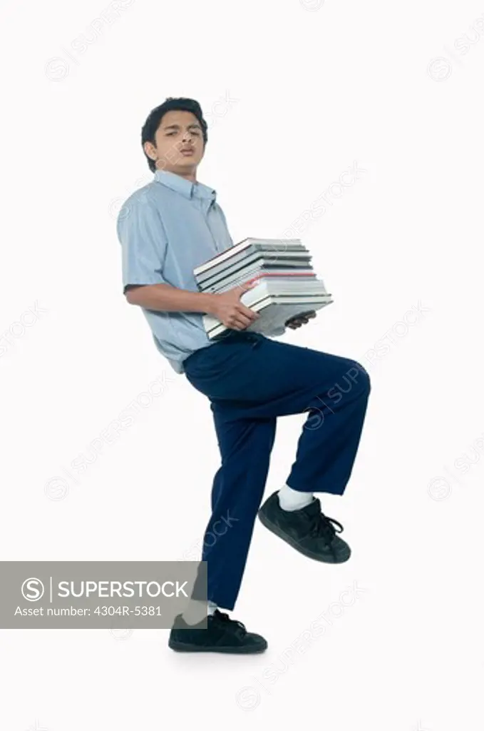 Teenage boy carrying books