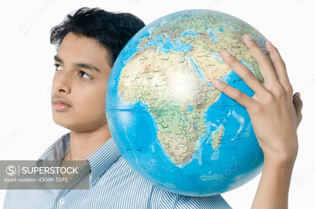 Teenage boy carrying globe
