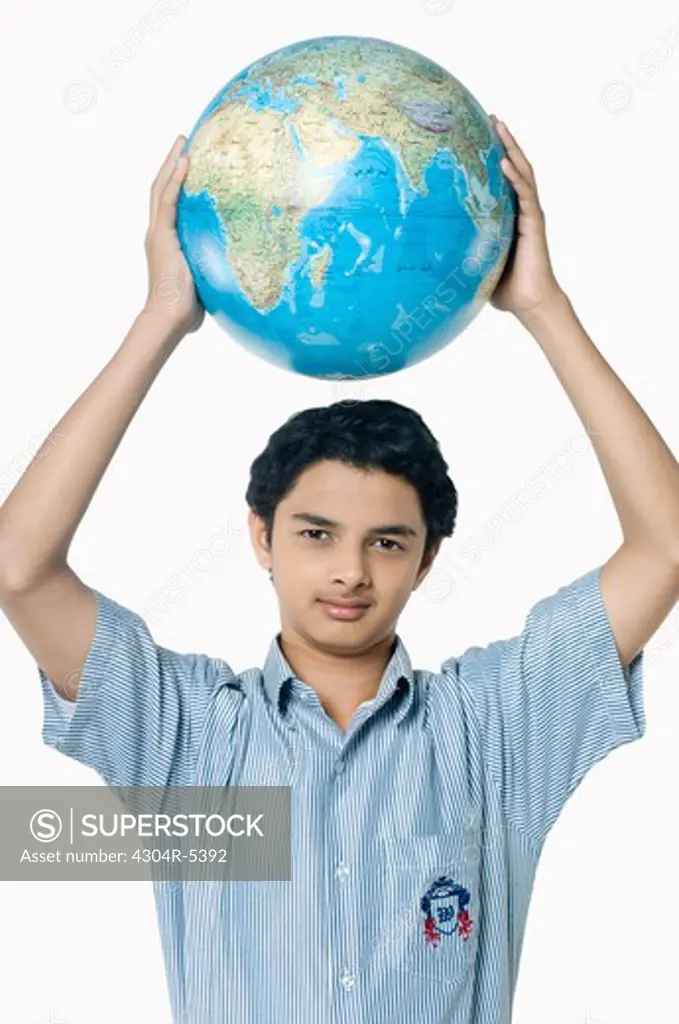 Teenage boy lifting globe