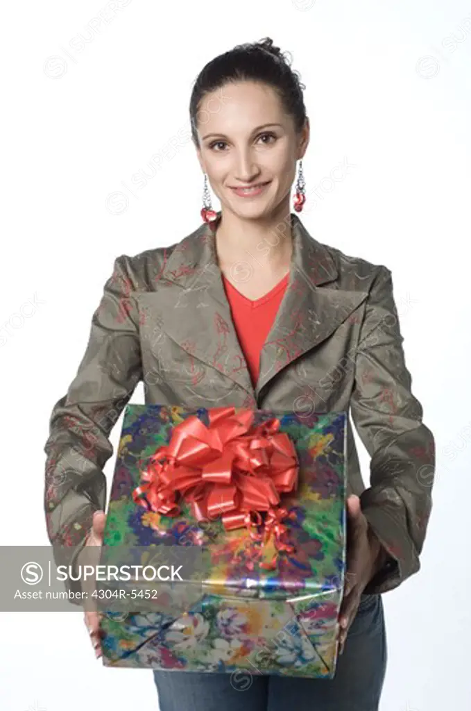 Young woman holding gift box, portrait
