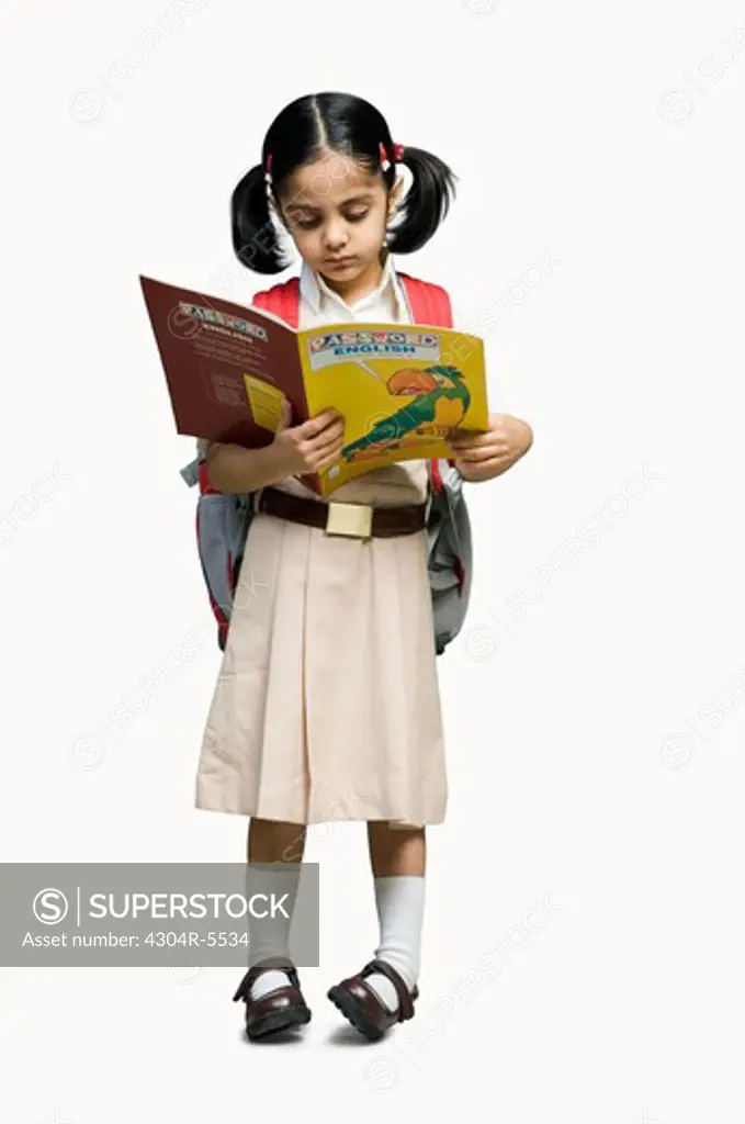 Girl (6-7) reading book