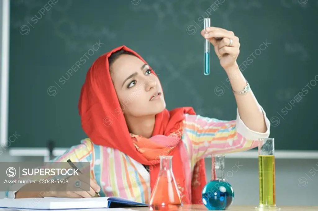 Teacher holding measuring tube