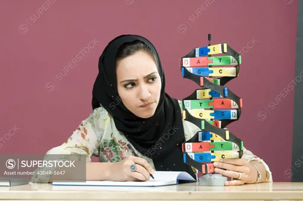 Woman looking at helix model