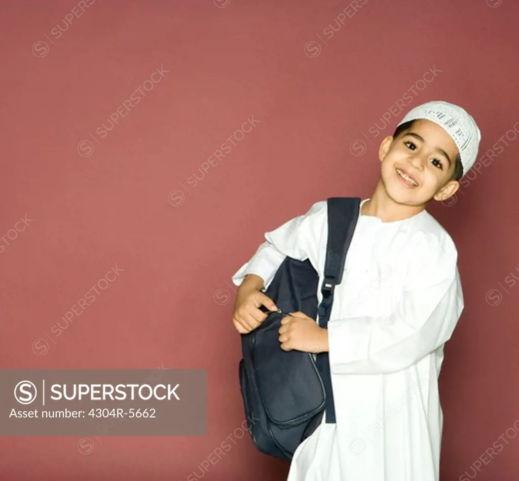 Boy (8-9) carrying shoulder bag, portrait, smiling