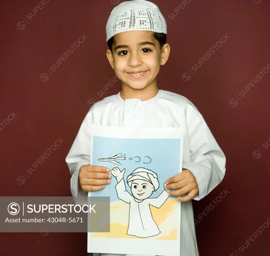 Boy (8-9) holding painting, smiling, portrait