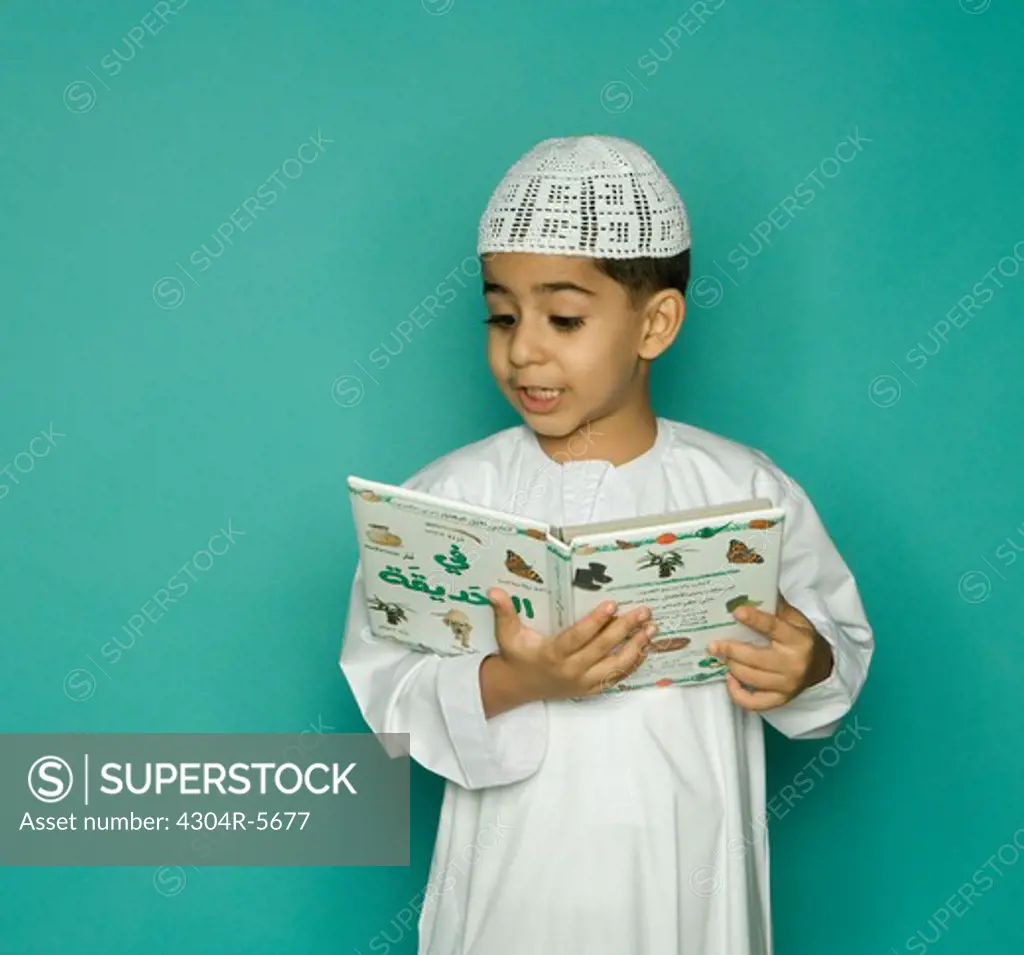 Boy (8-9) reading book