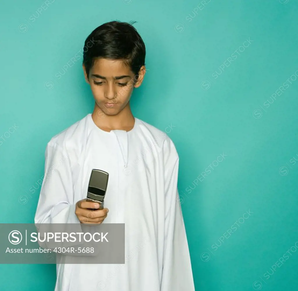 Boy (10-11) looking at mobile phone